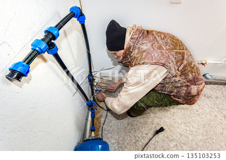 To secure heating cable on incoming water pipe homeowner uses plastic ties. To secure heating cable on incoming water pipe homeowner uses plastic ties. 135103253
