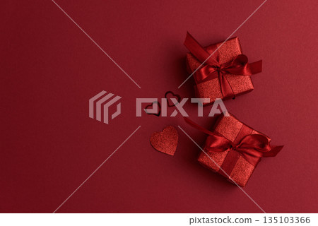 Red Glitter Gift Boxes and Hearts on Festive Background for Valentine's Day Celebration 135103366