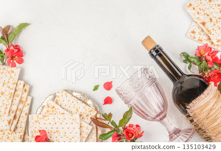 Passover matzah bread with wine bottle and glass on light background Passover matzah bread with wine bottle and glass on light background 135103429