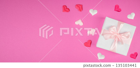 White gift box with pink ribbon and hearts on pink background with copy space, top view White gift box with pink ribbon and hearts on pink background with copy space, top view 135103441