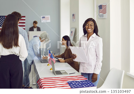Portrait of a happy african american woman employee work in USA voting center. 135103497