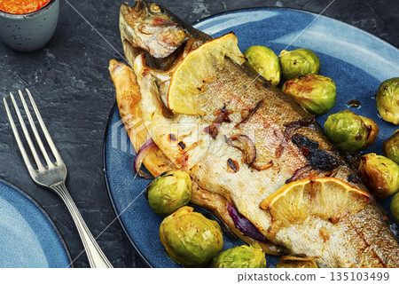 Trout baked with brussels sprouts. 135103499