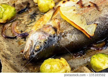Whole trout fish baked in an oven. Whole trout fish baked in an oven. 135103502