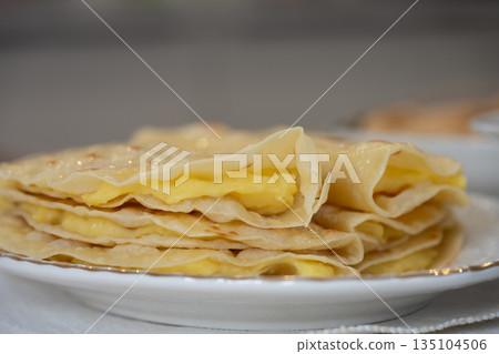 Thin qystybiy folded in half and stacked on a plate Thin qystybiy folded in half and stacked on a plate 135104506