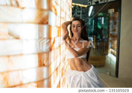 Long-haired pretty young woman in a spa center Long-haired pretty young woman in a spa center 135105029