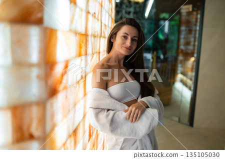 Long-haired pretty young woman in a spa center 135105030