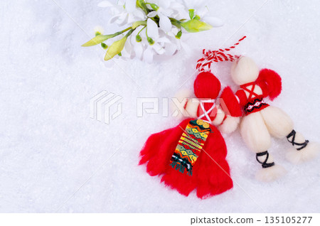 Spring background with white snow, snowdrops flowers and Bulgarian symbol of spring martenitsa. Spring background with white snow, snowdrops flowers and Bulgarian symbol of spring martenitsa. 135105277