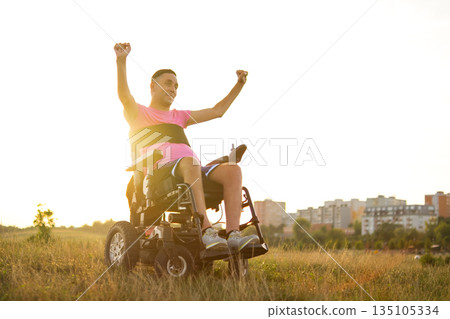 Wheelchair user celebrating happiness and life success. Inspirational lifestyle image showing emotional freedom, confidence, and joy of living. 135105334