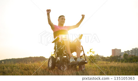 Happy disabled man celebrating life and personal victory at sunset. Happy disabled man celebrating life and personal victory at sunset. 135105363