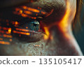 The image captures a mid-close shot of a human face focusing on a blinking eye. The eye reflects colorful lights, creating an intriguing visual effect. 135105417