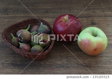 Figs and apples on wood background Figs and apples on wood background 135105523