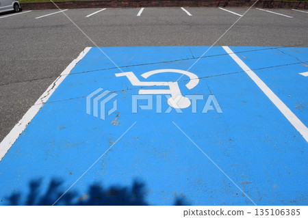 Wheelchair mark caring parking lot 135106385