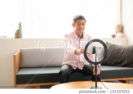 Senior man streaming video Senior man streaming video 135107052