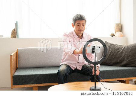 Senior man streaming video Senior man streaming video 135107053