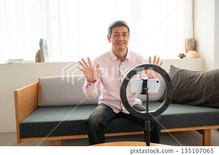 Senior man streaming video 135107065