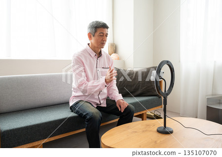 Senior man streaming video Senior man streaming video 135107070