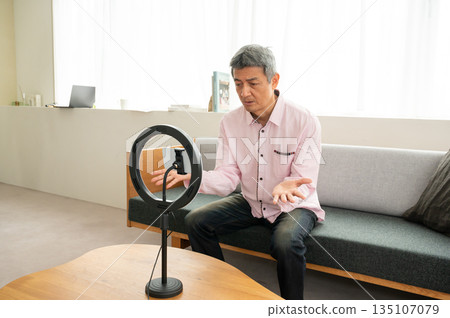 Senior man streaming video Senior man streaming video 135107079