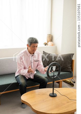 Senior man streaming video Senior man streaming video 135107081