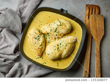 delicious chicken breast meat with creamy sauce on cooking pan 135108077