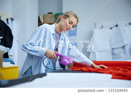 Woman using comprehensive method involving multiple stages to dye textile materials Woman using comprehensive method involving multiple stages to dye textile materials 135109495