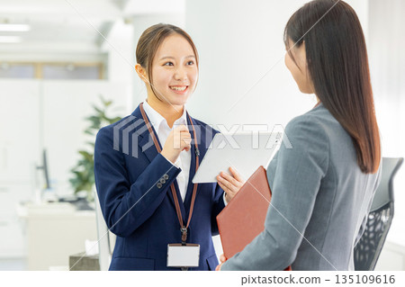 office workers having a conversation office workers having a conversation 135109616