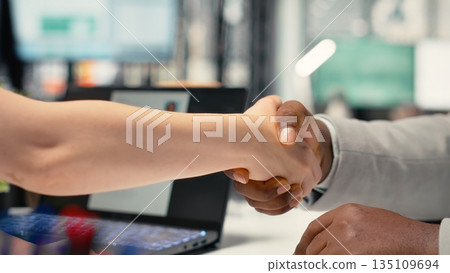 Recruiter and confident applicant sharing handshake after successful interview, confirming the start of employment, onboarding and agreement on contract terms within hiring process. Recruiter and confident applicant sharing handshake after successful interview, confirming the start of employment, onboarding and agreement on contract terms within hiring process. 135109694