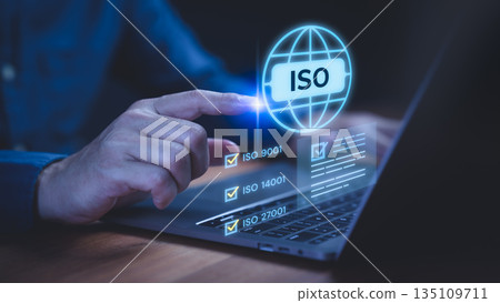 ISO certification concept with person using laptop and digital checklist, symbolizing international quality standard, compliance management, business improvement, data security certification system. 135109711