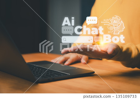 AI chatbot concept showing a person using a laptop with virtual chat icons, symbolizing artificial intelligence communication, automation, and digital customer support technology. 135109733