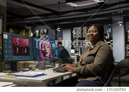 Black female editor using AI program turning text prompt into photos, retouching and editing after. Photographer uses text to image artificial intelligence generator for portfolio pictures. Black female editor using AI program turning text prompt into photos, retouching and editing after. Photographer uses text to image artificial intelligence generator for portfolio pictures. 135109765