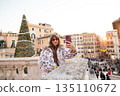 Woman taking a festive selfie near the Spanish Steps in Rome 135110672