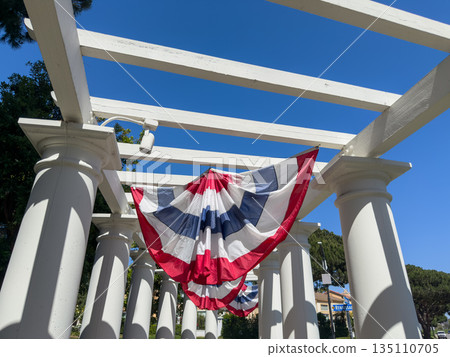 American flag against blue sky. American flag against blue sky. 135110705