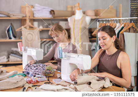 Two female tailors working in the workshop 135111575