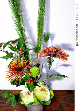 New Year's flowers such as pine, chrysanthemum, and senryo displayed in a vase 135111604