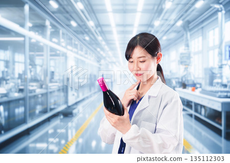一位身穿白大褂的女士正在從事葡萄酒研發工作。 一位身穿白大褂的女士正在從事葡萄酒研發工作。 135112303