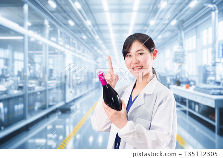 A woman in a white coat working on wine research and development A woman in a white coat working on wine research and development 135112305