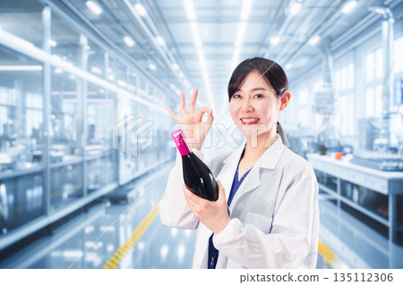 A woman in a white coat working on wine research and development A woman in a white coat working on wine research and development 135112306