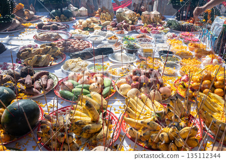 Various kind of food on table offering to the god or angel in mixed culture of Buddhist and Hindu religion in Thailand. Offerings, which can be flowers, food, or other gifts, are part of puja (worship Various kind of food on table offering to the god or angel in mixed culture of Buddhist and Hindu religion in Thailand. Offerings, which can be flowers, food, or other gifts, are part of puja (worship 135112344