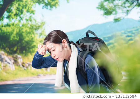 A young woman exhausted outdoors 135112594