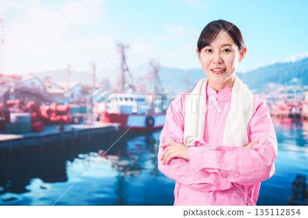 Young woman working as a fisherman Young woman working as a fisherman 135112854