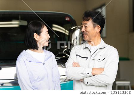 Middle-aged man and woman posing in front of a truck Construction image Middle-aged man and woman posing in front of a truck Construction image 135113368