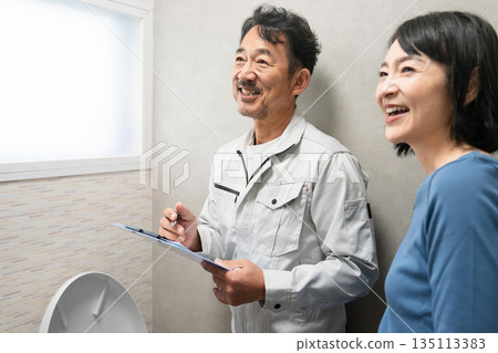 Repairman inspecting the toilet Lifestyle image 135113383