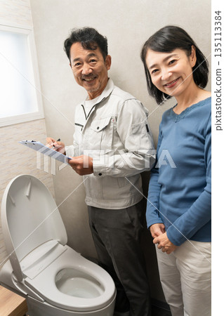 Repairman inspecting the toilet Lifestyle image 135113384