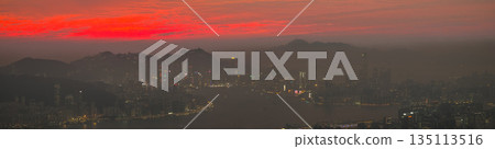 Dec 31 2025 Crimson sunset glow over Hong Kong city skyline 135113516