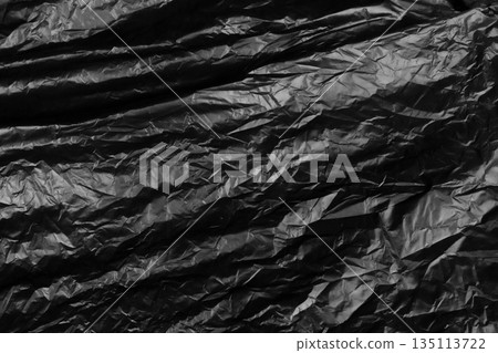 garbage bag is crumpled dark black garbage bag is crumpled dark black 135113722