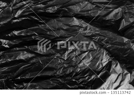garbage bag is crumpled dark black 135113742