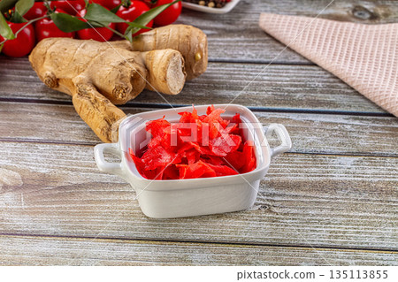 Red marinated sliced ginger roots Red marinated sliced ginger roots 135113855