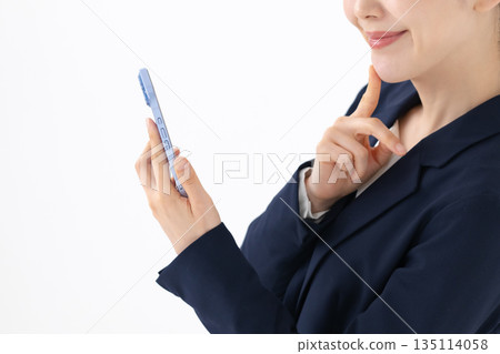 Woman holding a smartphone Woman holding a smartphone 135114058