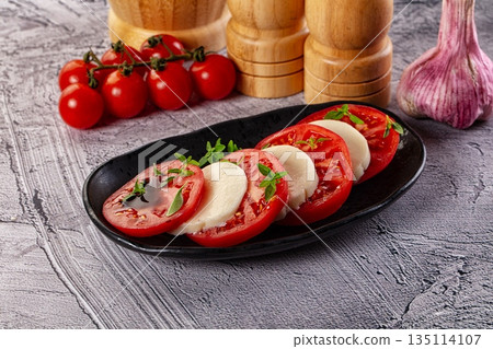 Italian caprese salad with mozzarella, tomato and basil Italian caprese salad with mozzarella, tomato and basil 135114107