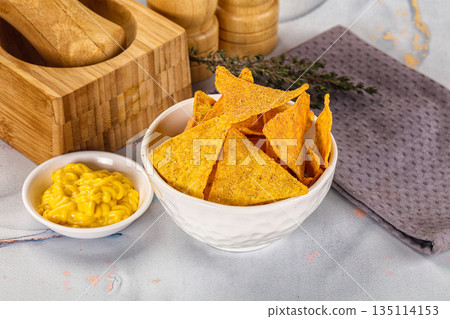Corn nachos chips with cheese dip Corn nachos chips with cheese dip 135114153