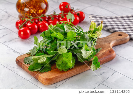 Heap of green fresh coriander stems 135114205